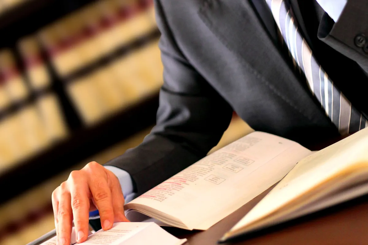 An attorney reading a case file at his desk